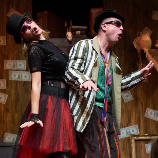 Dwoje aktorów. Agnieszka i kolega aktor, w ekspresyjnym tańcu. Agnieszka w czerwonej tiulowej spódnicy, w przeciwsłonecznych okularach, kapeluszu, śpiewa.